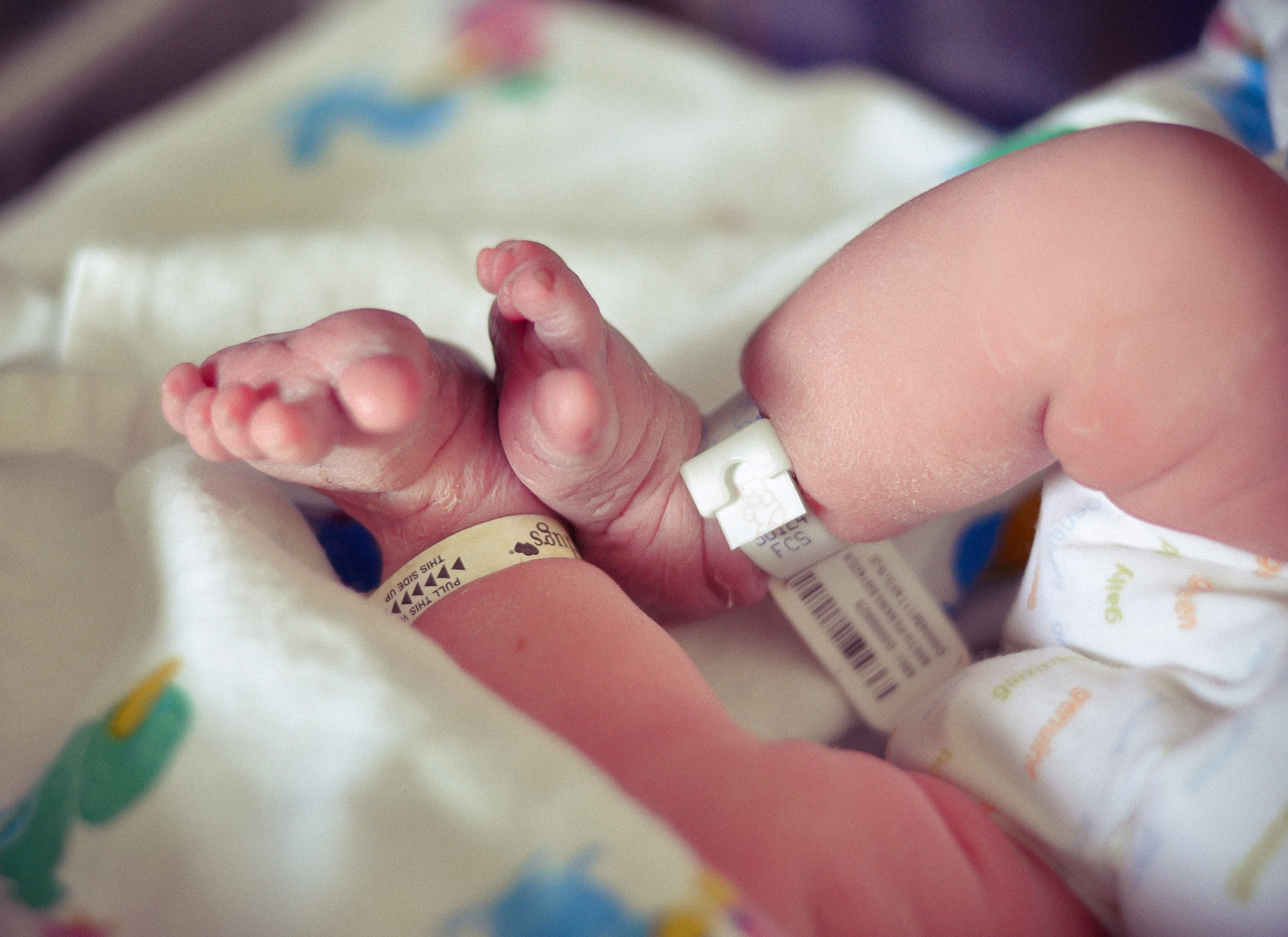newborn feet, and her gDiaper cloth diaper in the hospital